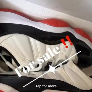 Retro Jordan 11s Low red black and white